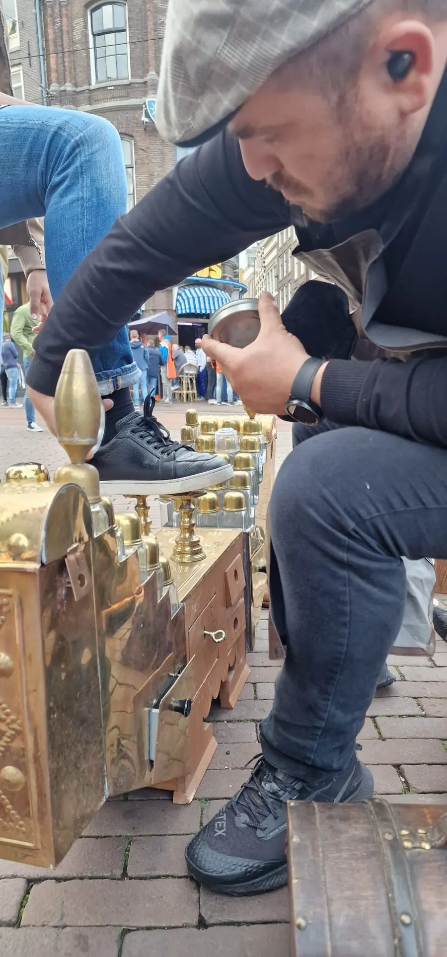 Ali verzorgt met de hand een schoen op zijn schoenpoetsstoel